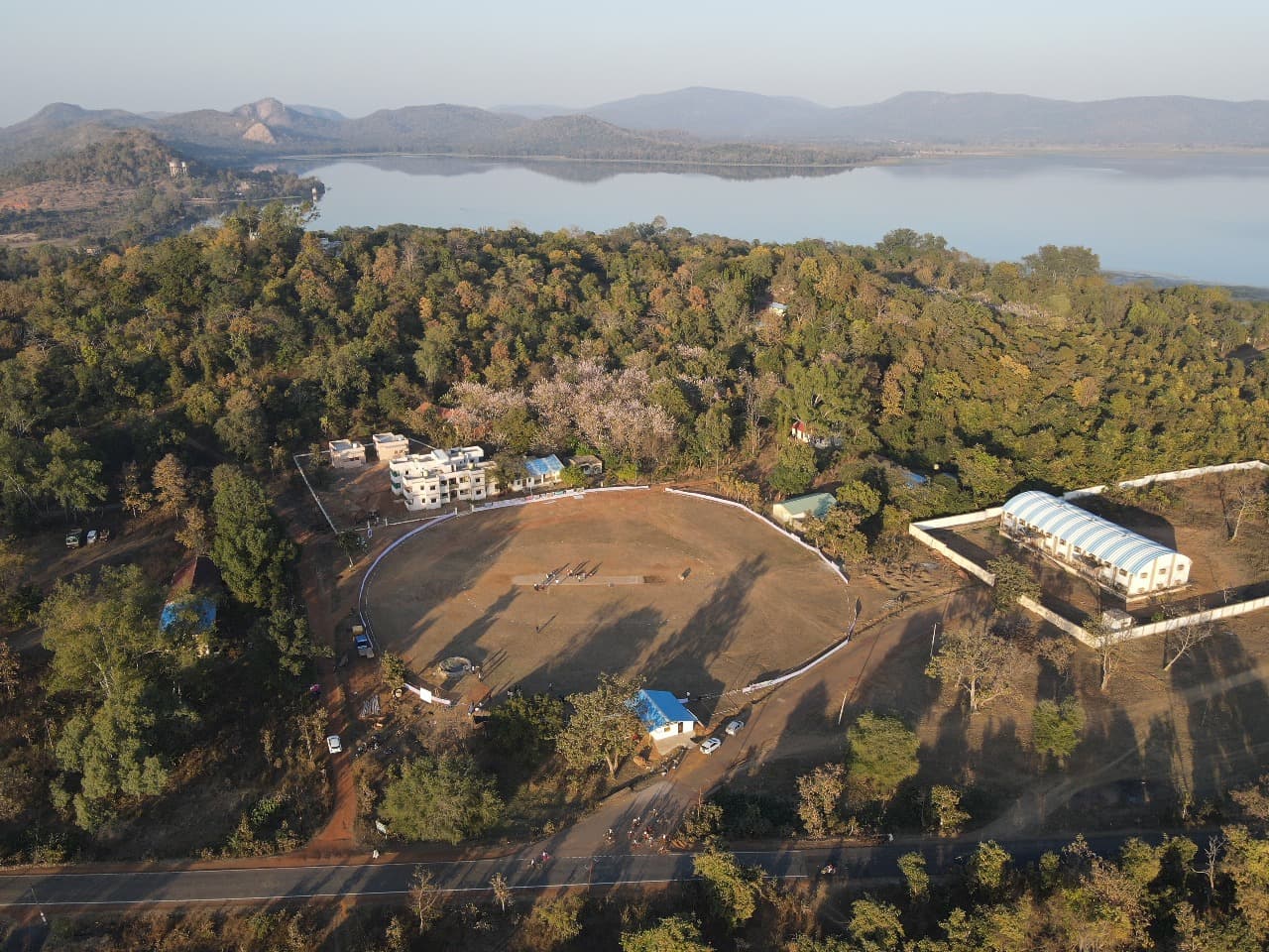 A bowler in mid-action, about to release the ball.