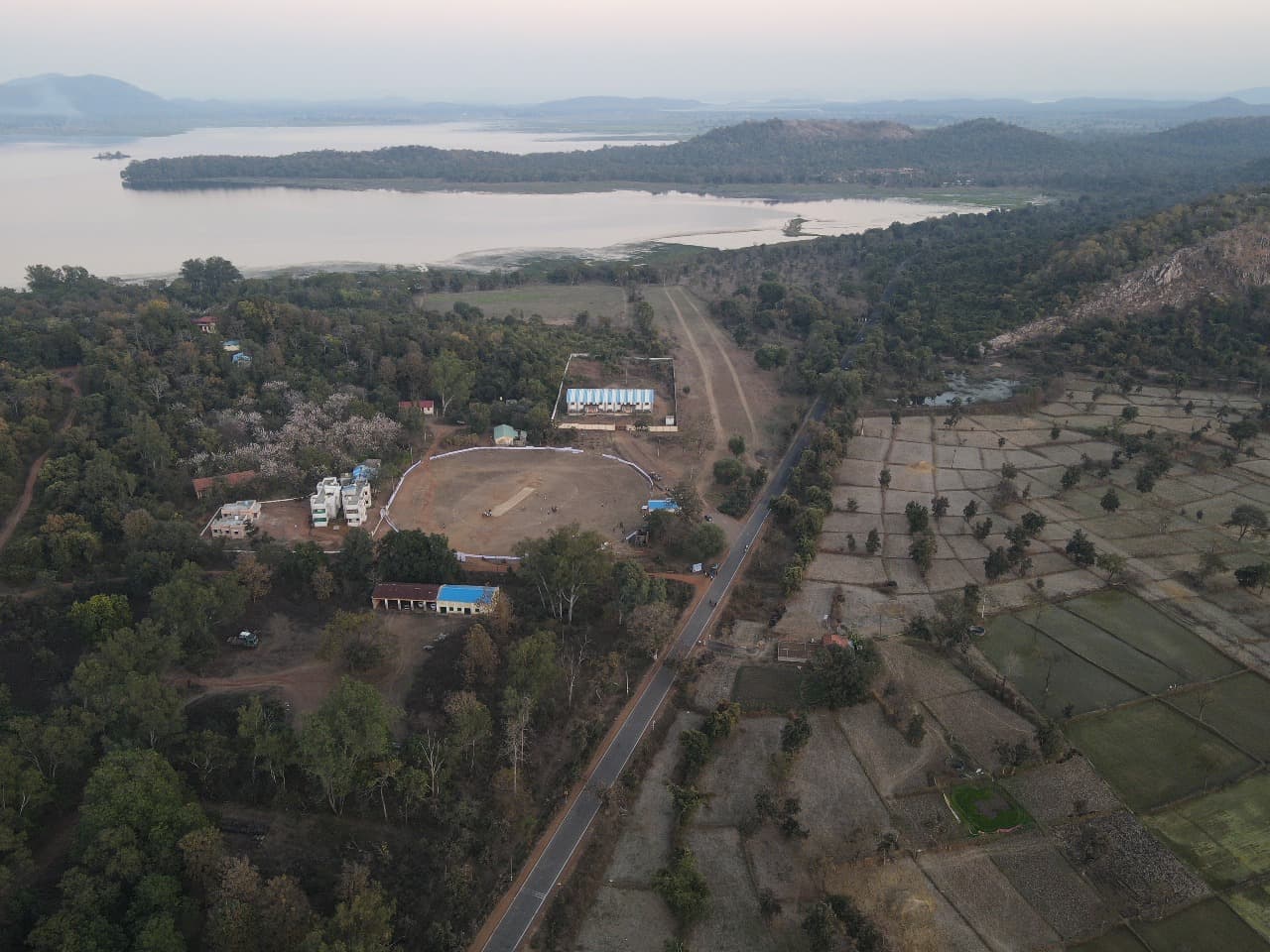 Players huddle together on a cricket field.